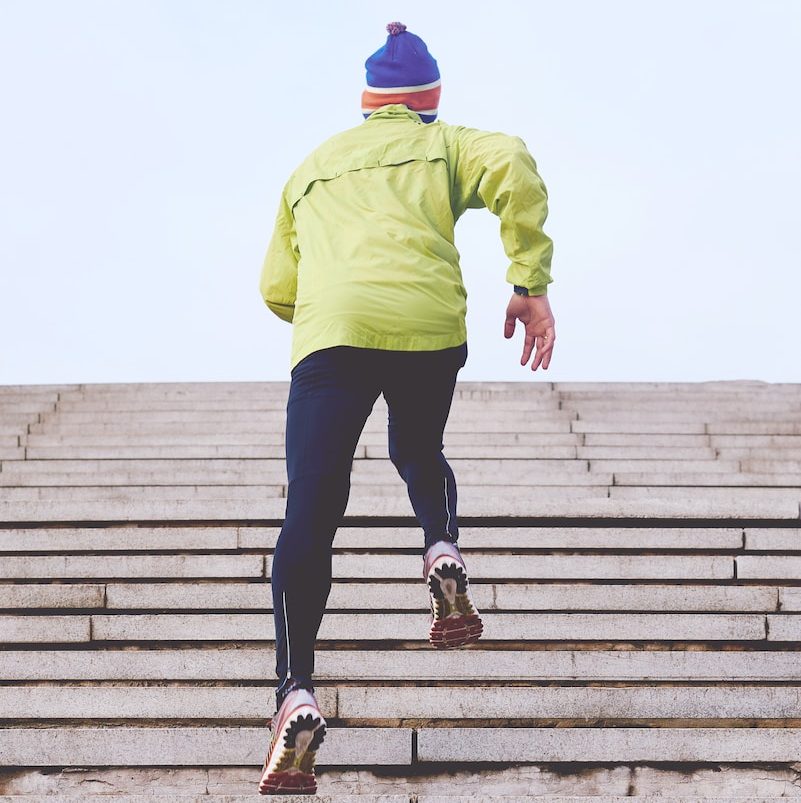 person climbing concrete stairs