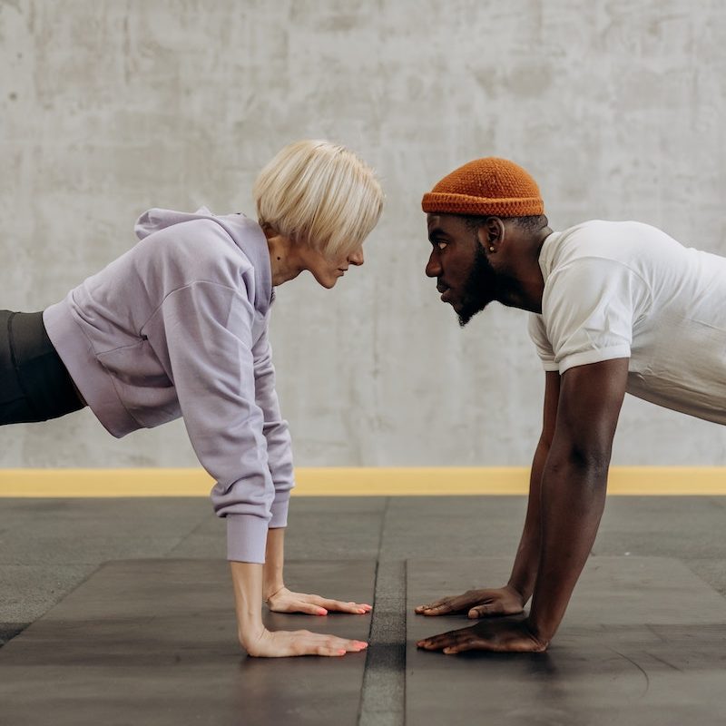 Man And Woman Doing Push Up Face To Face